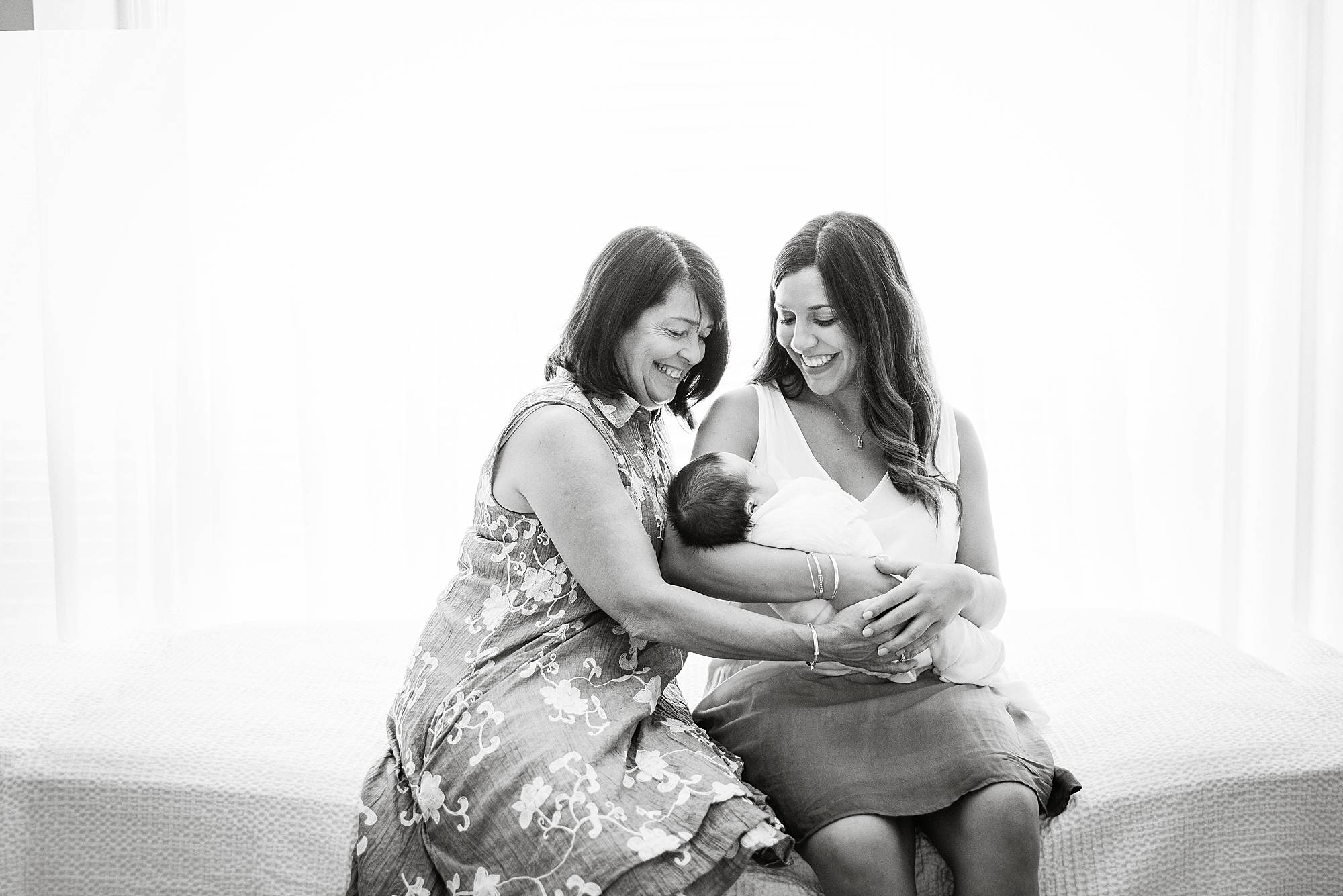 grandmother mom and baby in the nursery loving holding baby