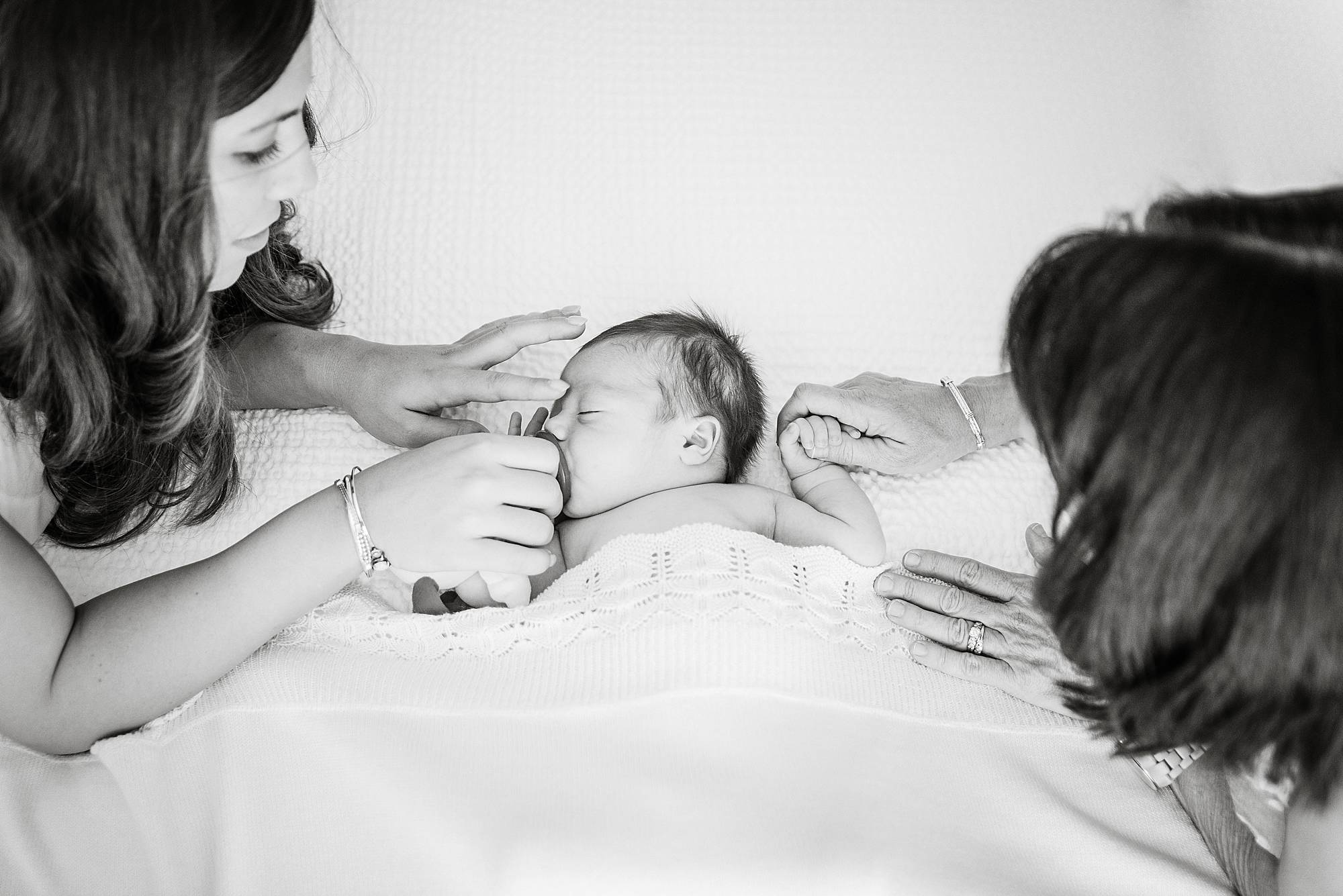 mother and child in nursery soothing baby during photo shoot