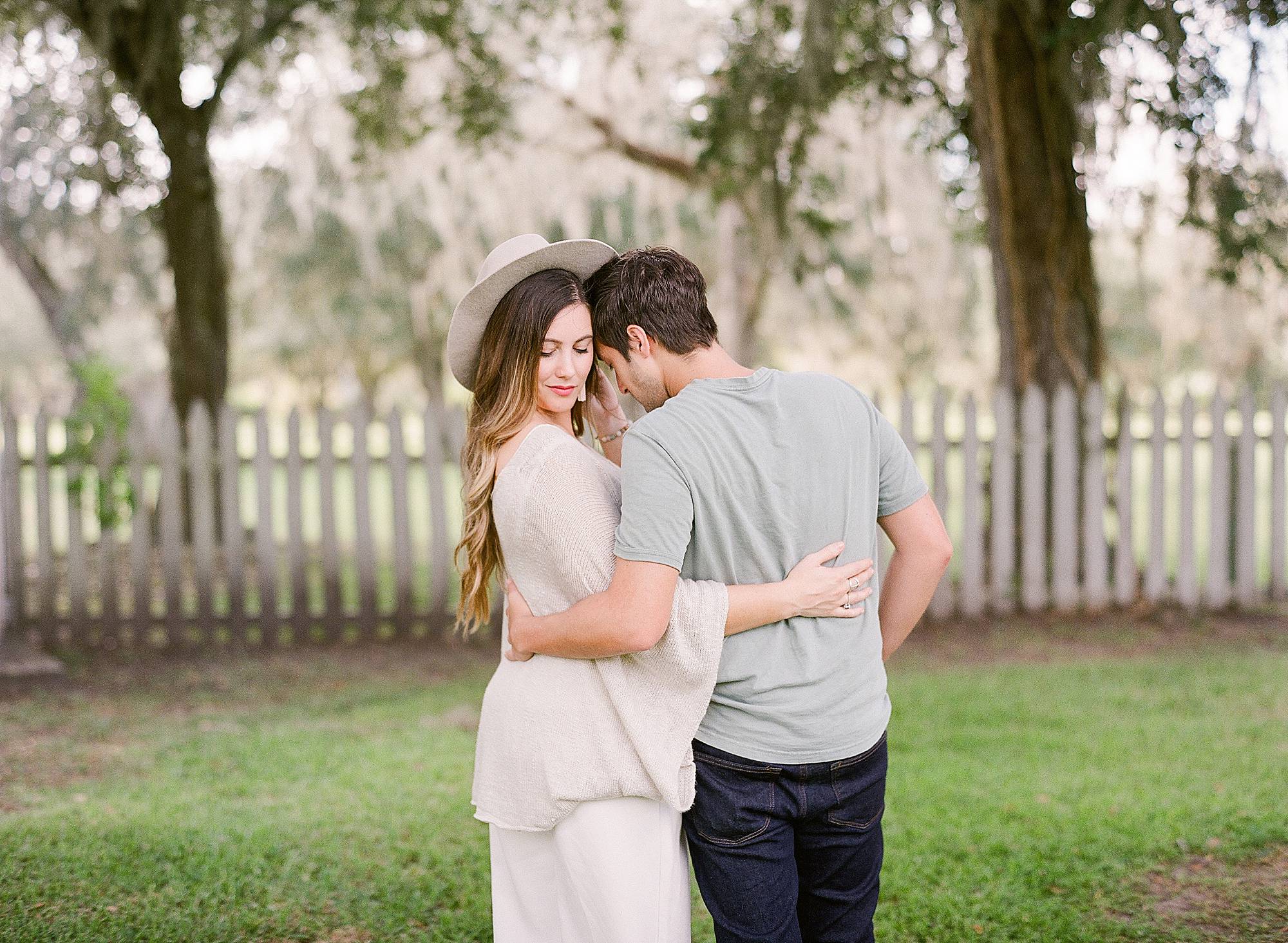 married couple poses with hat in south louisiana at Jungle Gardens