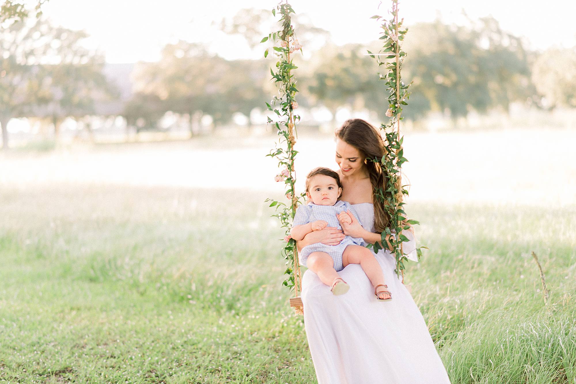 mother and son swinging on a swing