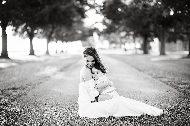 black and white portrait of mom snuggling baby