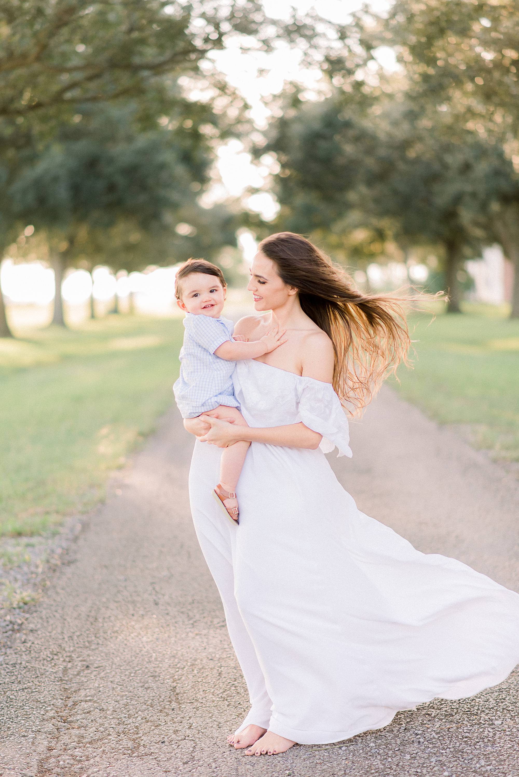 mother and child photographed in oak line alley at sunset