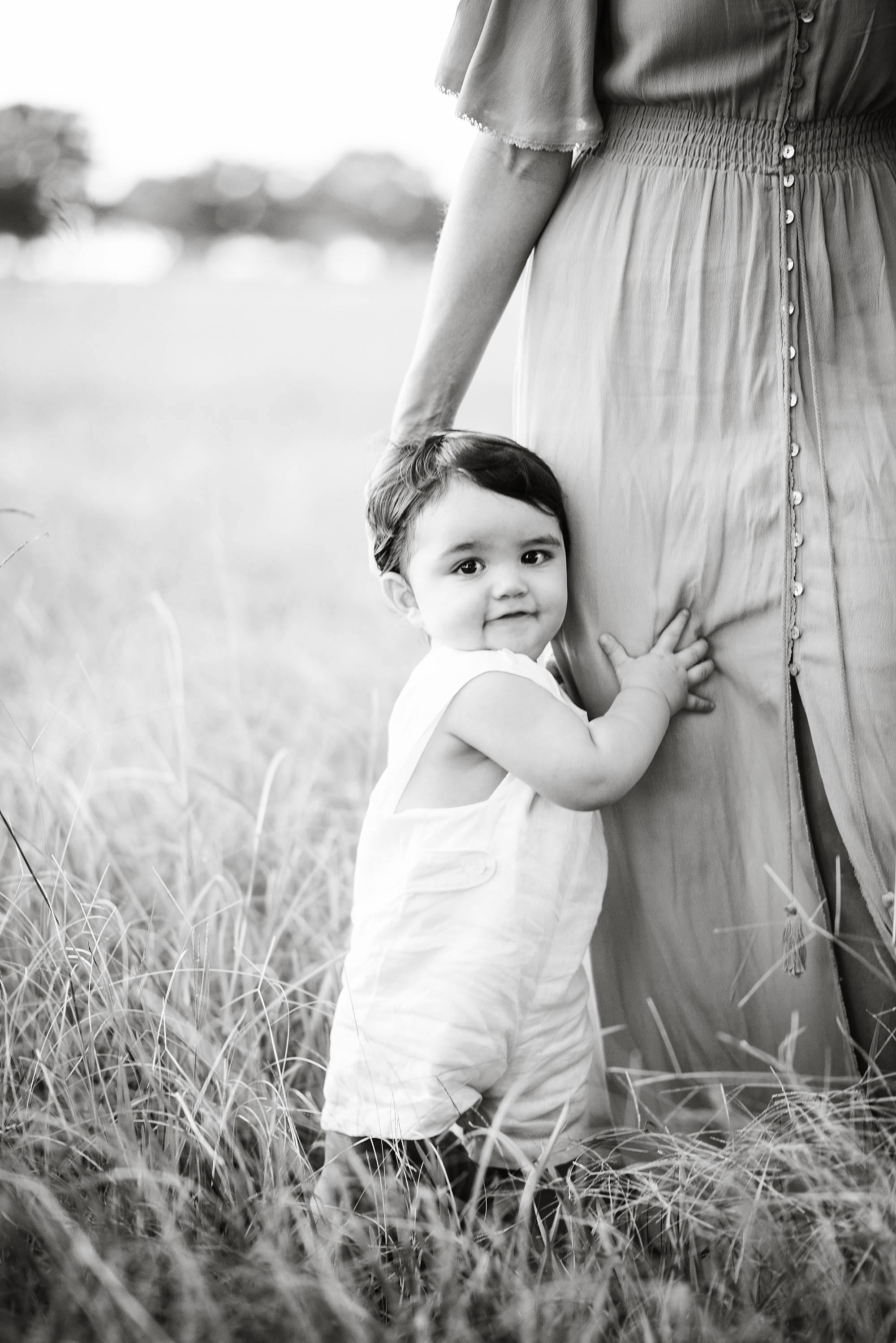 baby playing peek a boo with the photographer