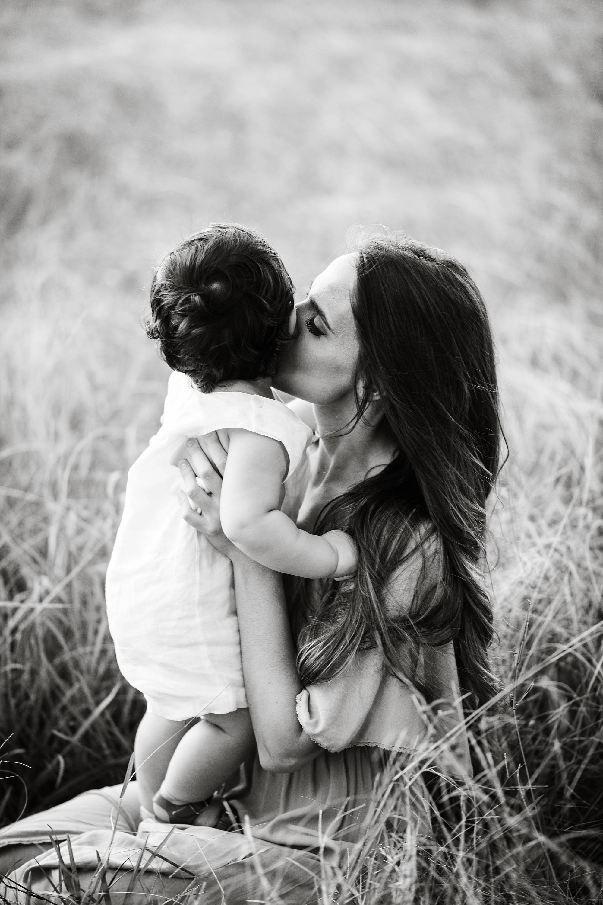 mommy kissing her baby's cheek