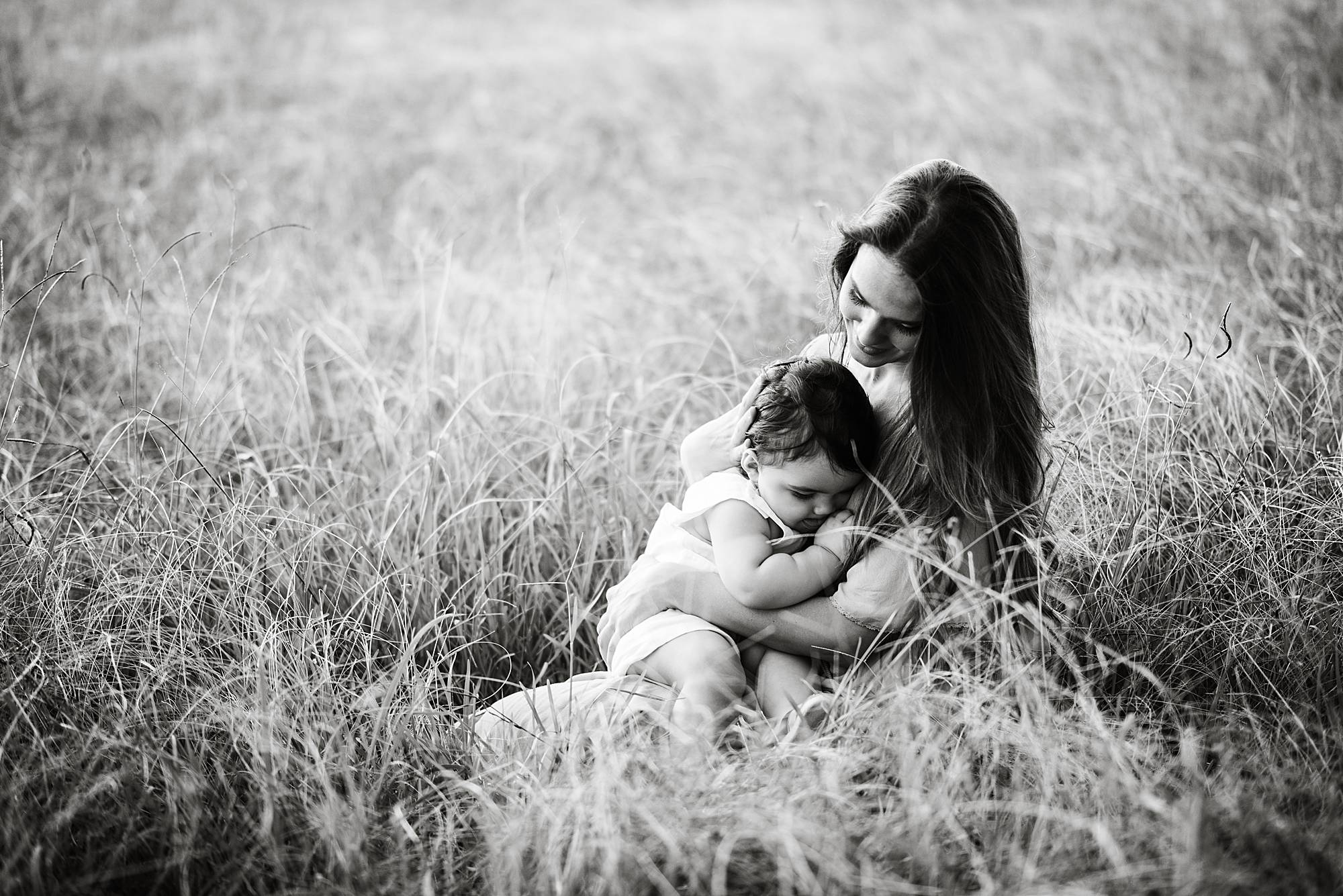 intimate portrait of baby clinging to mother