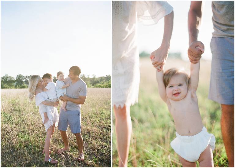 parents hold their children looking adoringly at them in a field in lafayette louisiana