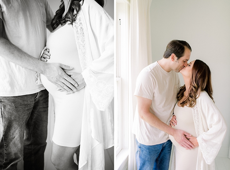 pregnancy with parents hugging and kissing in photography studio wearing all white 