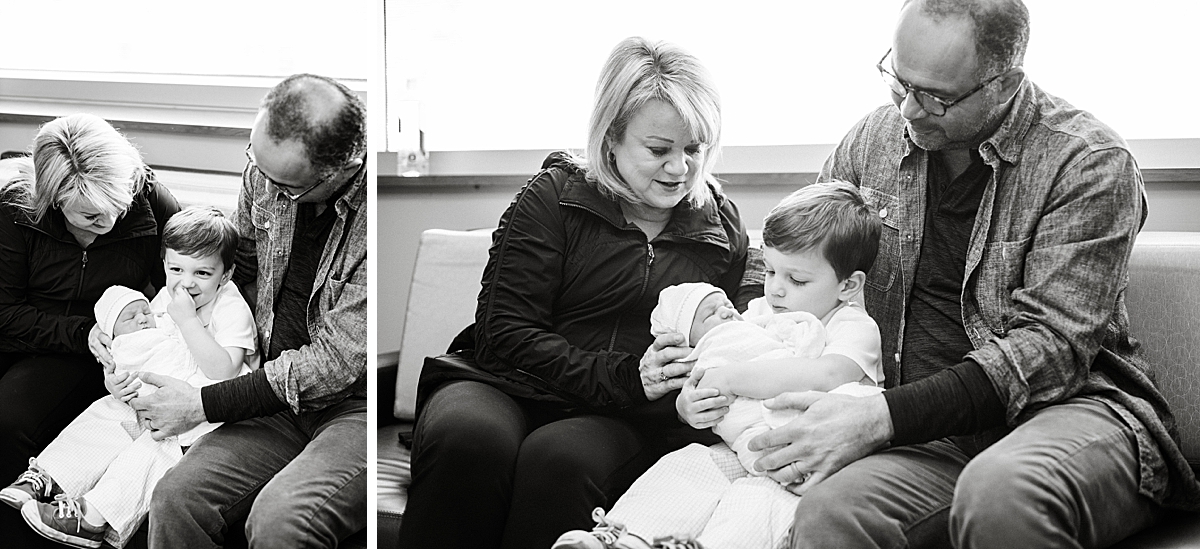 grandparents help hold grand baby in the hospital