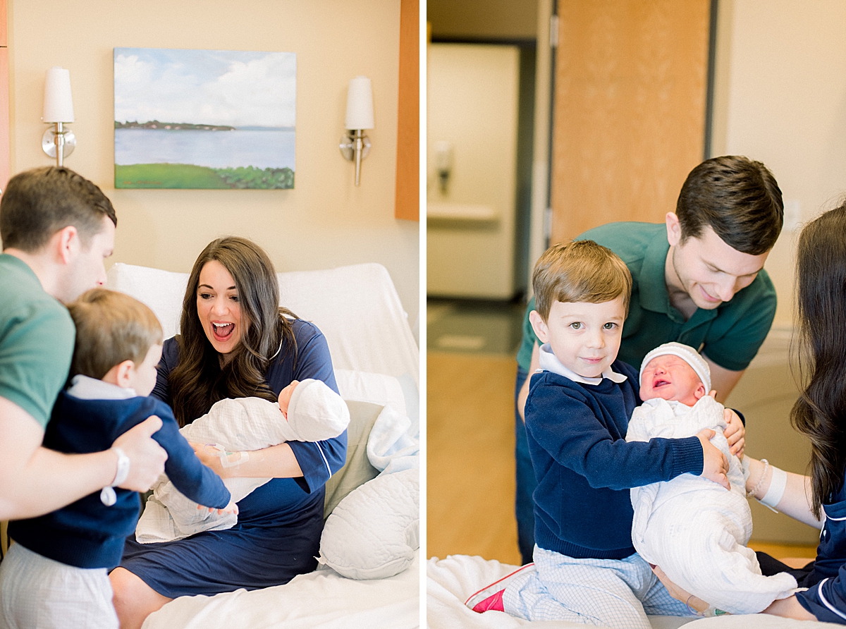 family in hospital introduces new born baby boy to his older brother. big brother holds new baby for the first time