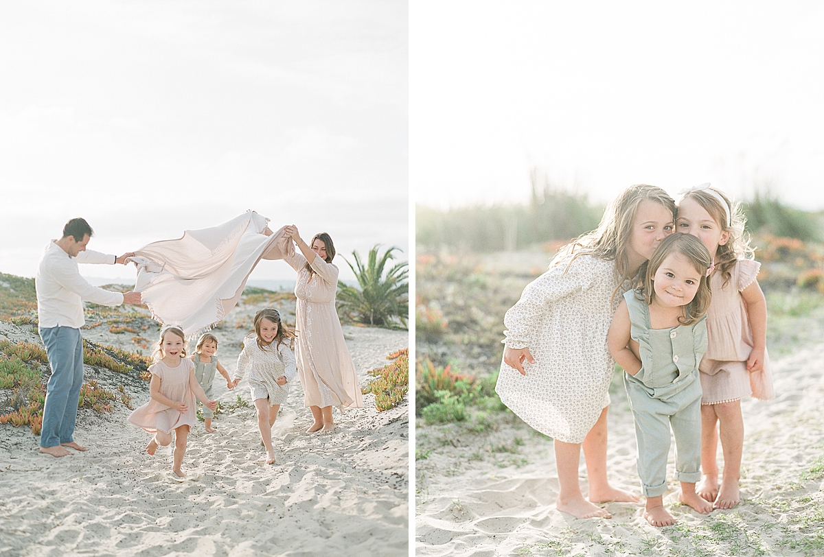 big sisters kiss little sister as they smile for the camera during their photography session on Coronado Beach in San Diego