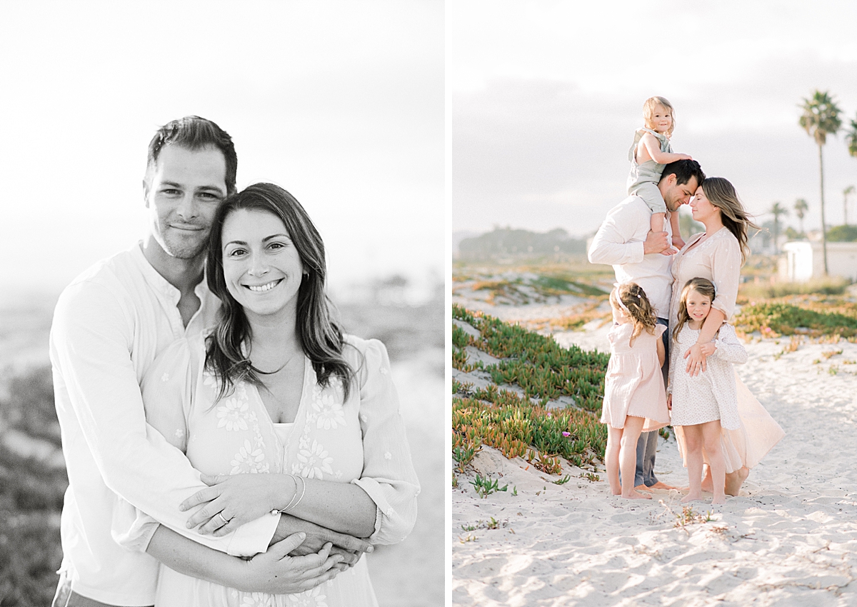 Mom and dad smile at the camera for a portrait on the beach in San Diego by photographer while children play