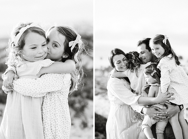 black and white image of family hugging together on a beach for a photography session in San Diego
