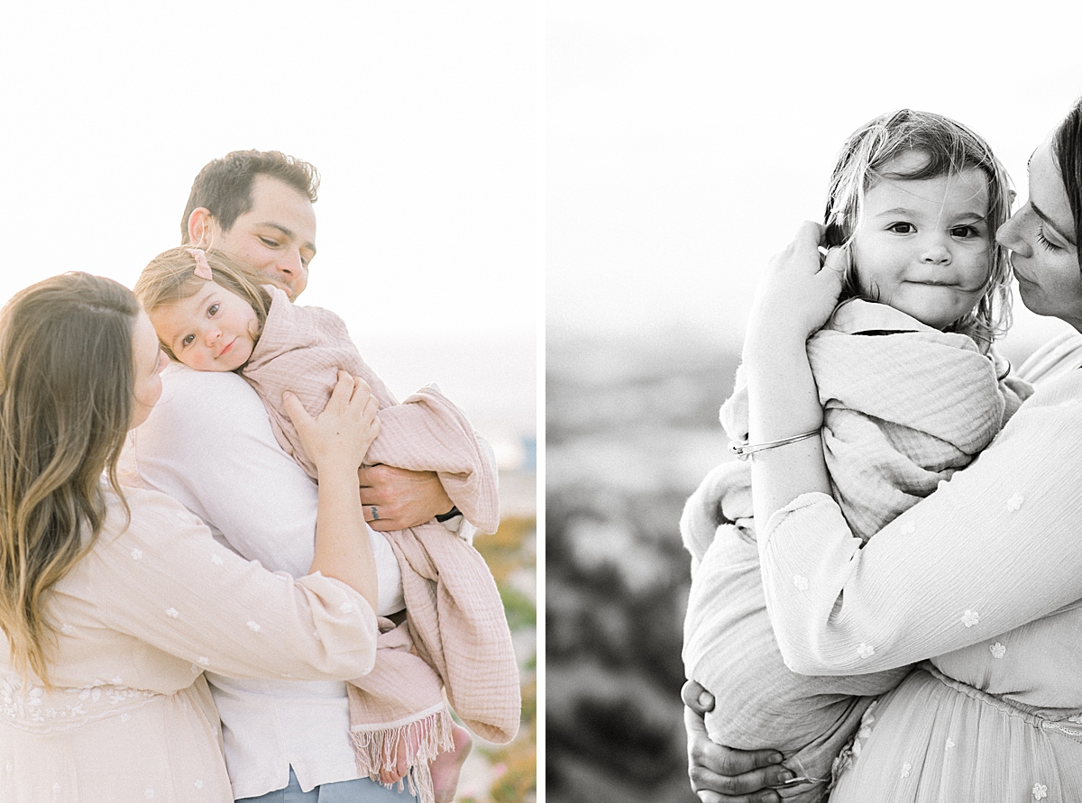 baby of the family gets held in a blanket while being consoled by mother