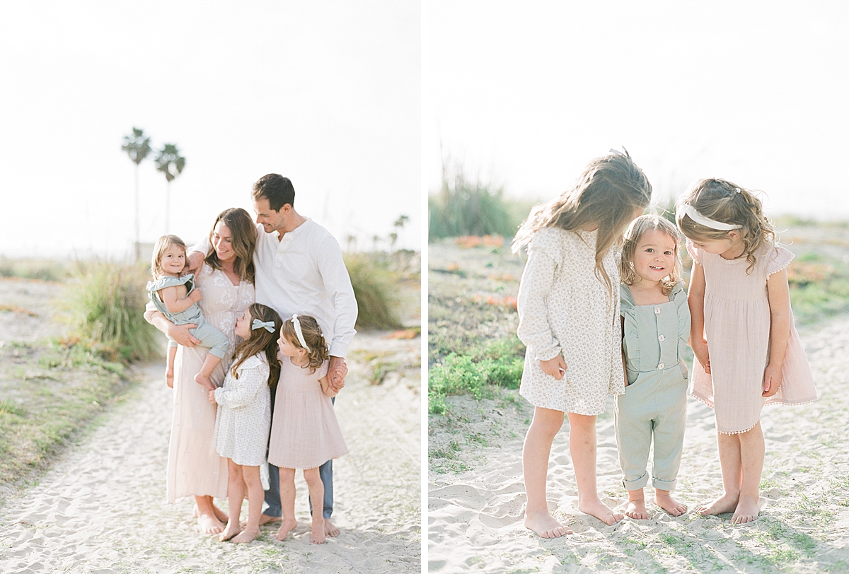 mom and dad hold the baby while the older siblings dance around 