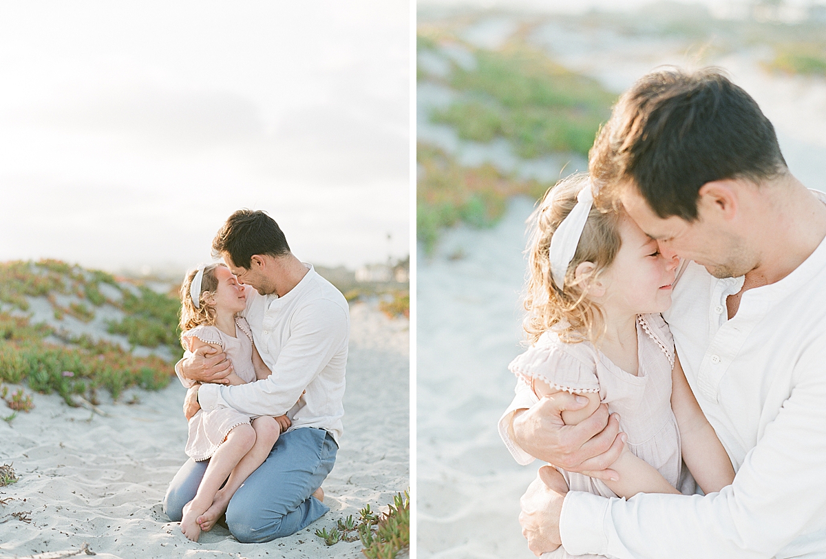 dad hugs and kisses little daughter 