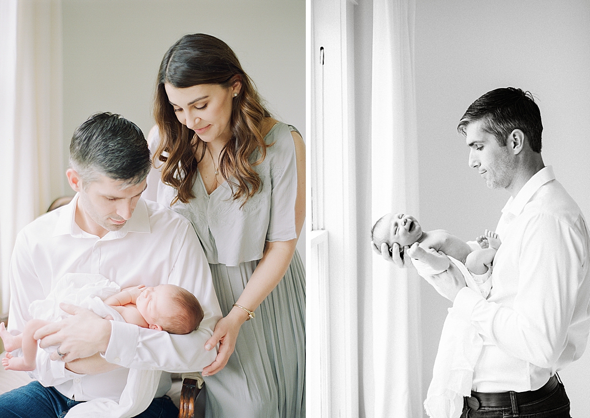 dad holding newborn baby as it gives a big smile