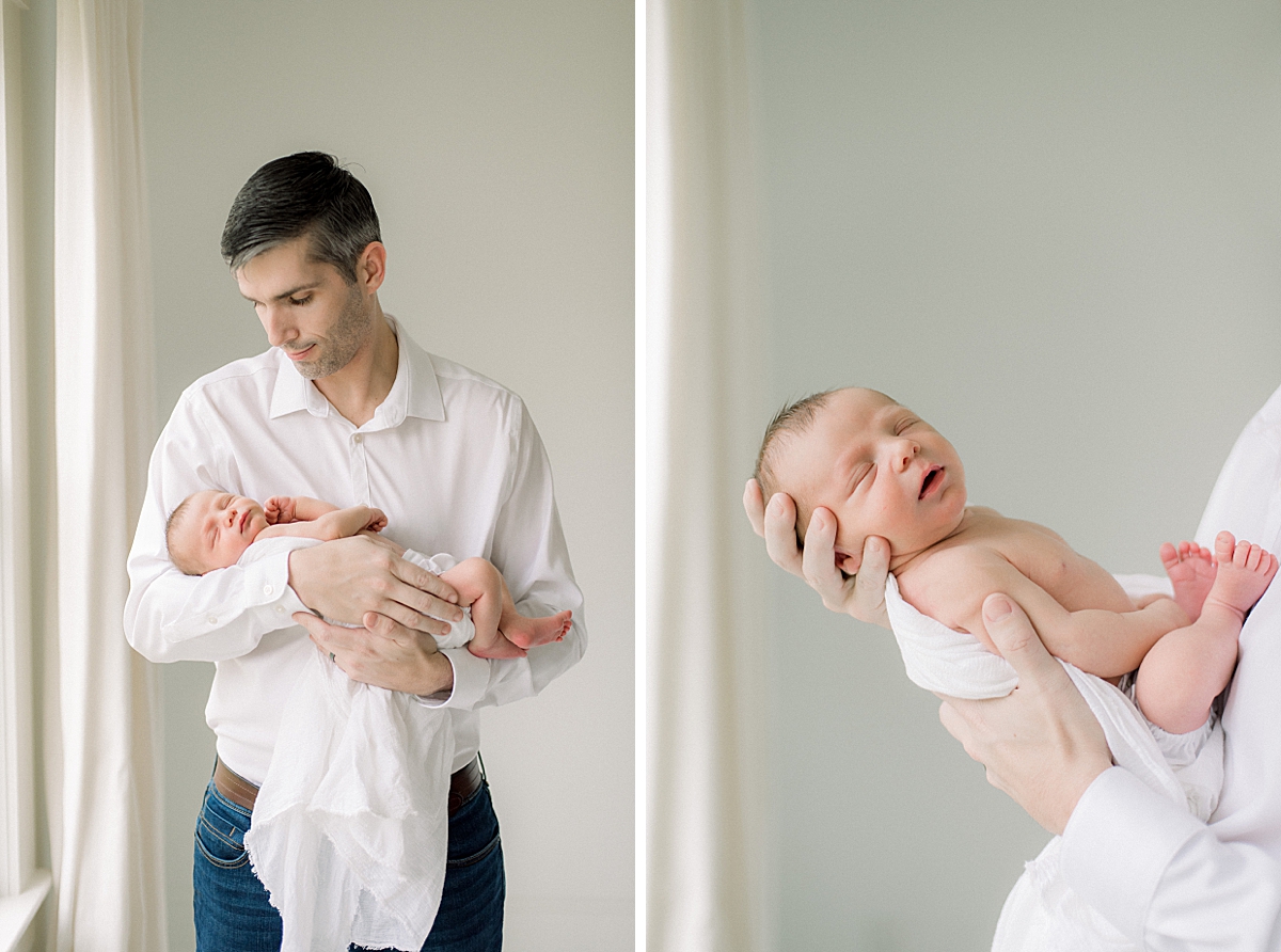 Newborn baby boy and his father holding him for the first time 