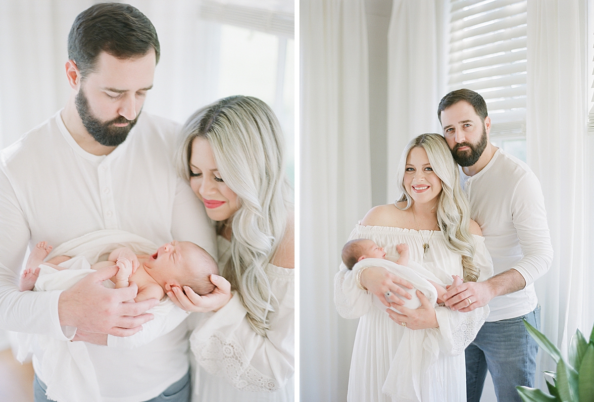 Mother and Father in their home holding their rainbow baby boy after they went through years of infertility