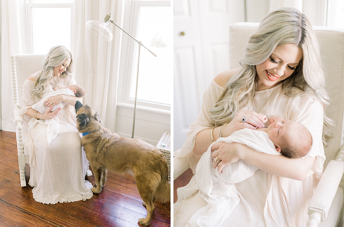 mother holds her newborn baby boy in the nursery as she rocks him to sleep in her antique rocker