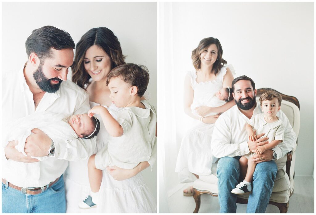 Family of four looking down at their newborn baby girl while toddler brother points to the bow in her hair