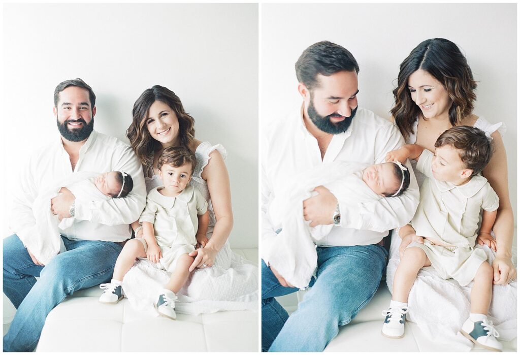 Family of four sitting on white couch smiling at the camera for a portrait inside a white photography studio located in Lafayette La